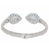 Elegant Pear Blue Topaz Sterling Silver Bracelet with detailed filigree design and turquoise accents.